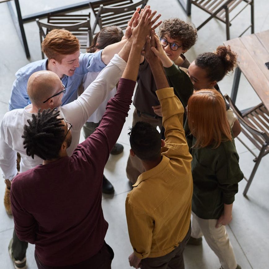 photo of people holding each other s hands